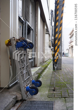 An old plastic cart propped up beside a building in a back alley. 138700595