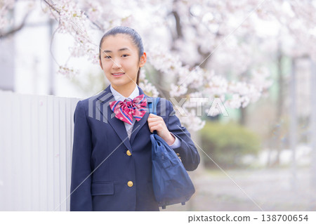 A student, a high school girl, walking under the cherry blossoms. 138700654