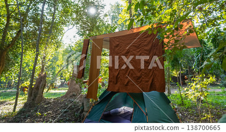 Forest tents, hanging robes and shaded paths create a clear retreat backdrop. The natural scene suits meditation and religion content. Forest tents, hanging robes and shaded paths create a clear retreat backdrop. The natural scene suits meditation and religion content. 138700665