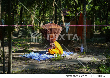 Forest tents, hanging robes and shaded paths create a clear retreat backdrop. The natural scene suits meditation and religion content. Forest tents, hanging robes and shaded paths create a clear retreat backdrop. The natural scene suits meditation and religion content. 138700670