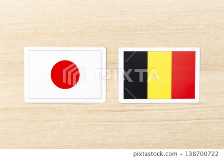 The flags of Japan and Belgium are placed on the table. The flags of Japan and Belgium are placed on the table. 138700722