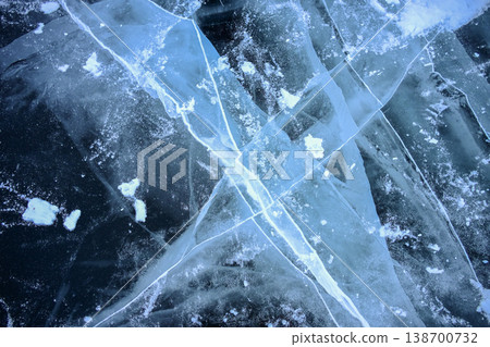Beautiful cracks iced surface of the frozen lake of Baikal lake with frost methane bubbles in winter season. 138700732