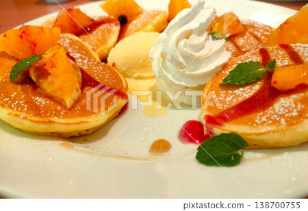 Luxurious fruit pancakes with orange and whipped cream Luxurious fruit pancakes with orange and whipped cream 138700755