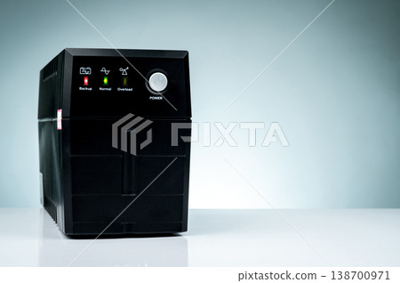 Uninterruptible power supply isolated on white background. Backup Power UPS with battery. UPS with stabilizer for home PC. Equipment for computer system at office for security. Power protection. 138700971