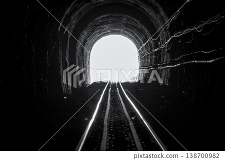 Train tunnel. Old railway in cave. Hope of life in the end of the way. Railroad of locomotive train in Thailand. Old architecture. Railway tunnel built in 1914. Travel and hope at the destination. Train tunnel. Old railway in cave. Hope of life in the end of the way. Railroad of locomotive train in Thailand. Old architecture. Railway tunnel built in 1914. Travel and hope at the destination. 138700982
