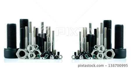 Metal bolts and nuts on white background. Fasteners equipment. Hardware tools. Stud bolt, hex nuts, and hex head bolts in workshop. Threaded fastener use in automotive engineering. Hexagonal bolt. Metal bolts and nuts on white background. Fasteners equipment. Hardware tools. Stud bolt, hex nuts, and hex head bolts in workshop. Threaded fastener use in automotive engineering. Hexagonal bolt. 138700995