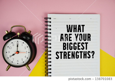 What Are Your Biggest Strengths? text written on notepad with alarm clock on pink background What Are Your Biggest Strengths? text written on notepad with alarm clock on pink background 138701083