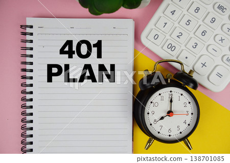 401 Plan text written on notepad with calculator and alarm clock on pink background 138701085