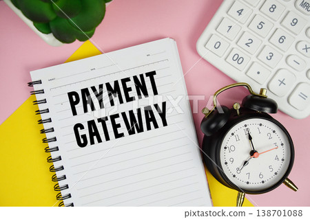 Payment Gateway text written on notepad with calculator and alarm clock on pink background Payment Gateway text written on notepad with calculator and alarm clock on pink background 138701088
