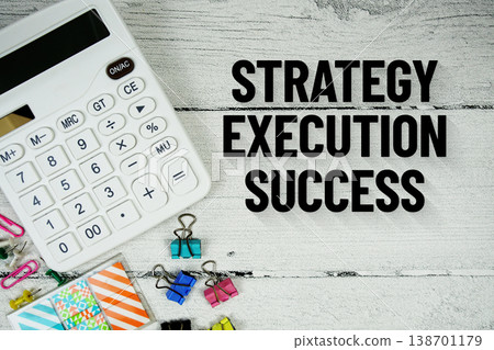 Strategy Execution Success text message with calculator and stationery on wooden background 138701179