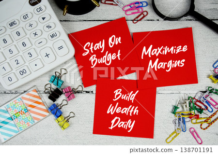 Stay On Budget, Maximize Margins, Build Wealth Daily text written on paper note with calculator and magnifying glass on wooden background Stay On Budget, Maximize Margins, Build Wealth Daily text written on paper note with calculator and magnifying glass on wooden background 138701191