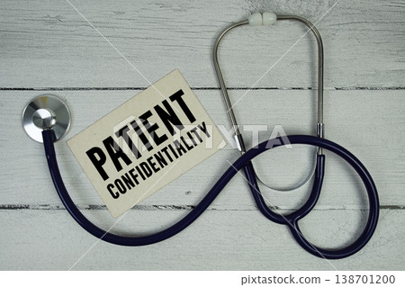 Patient Confidentiality text with Medical Stethoscope on wooden background Patient Confidentiality text with Medical Stethoscope on wooden background 138701200