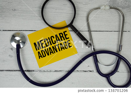Medicare Advantage text with Magnifying glass and Medical Stethoscope on wooden background Medicare Advantage text with Magnifying glass and Medical Stethoscope on wooden background 138701206