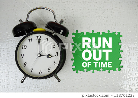 Run out of time text with alarm clock on green background Run out of time text with alarm clock on green background 138701222