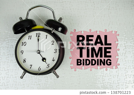 Real Time Bidding (RTB) text with alarm clock on pink background Real Time Bidding (RTB) text with alarm clock on pink background 138701223