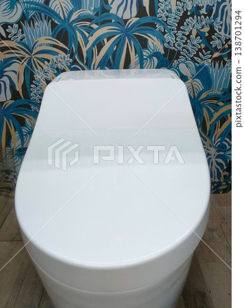 A clean Western-style toilet with botanical wallpaper. A clean Western-style toilet with botanical wallpaper. 138701294