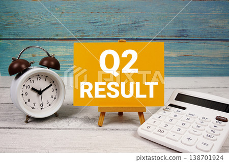 2nd Quarter Financial Report text written on paper card with calculator and alarm clock on wooden background 2nd Quarter Financial Report text written on paper card with calculator and alarm clock on wooden background 138701924