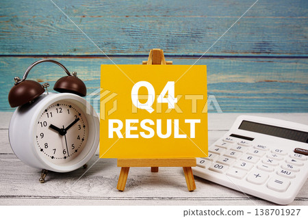 4th Quarter Financial Report text written on paper card with calculator and alarm clock on wooden background 4th Quarter Financial Report text written on paper card with calculator and alarm clock on wooden background 138701927