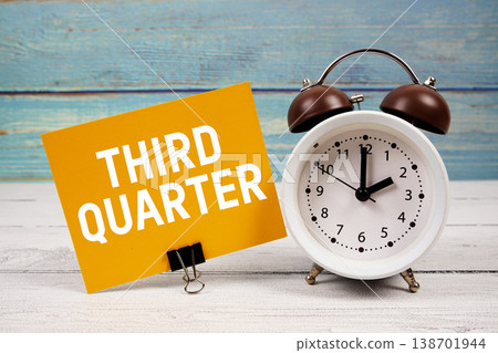 Third Quarter text written on paper card with alarm clock on wooden background 138701944