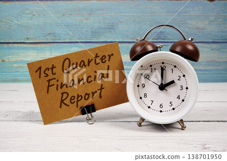 1st Quarter Financial Report text written on paper card with alarm clock on wooden background 138701950