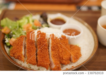 Katsu curry served with two types of curry sauce Katsu curry served with two types of curry sauce 138702010