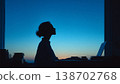 A woman spending time in her room at dusk 138702768