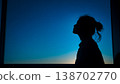 A woman spending time in her room at dusk 138702770
