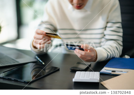 Financial owe, hand of asian man sitting, holding credit card, stressed by calculate expense from invoice or bill, no money Financial owe, hand of asian man sitting, holding credit card, stressed by calculate expense from invoice or bill, no money 138702848