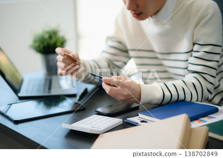Financial owe, hand of asian man sitting, holding credit card, stressed by calculate expense from invoice or bill, no money 138702849