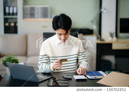 Financial owe, hand of asian man sitting, holding credit card, stressed by calculate expense from invoice or bill, no money Financial owe, hand of asian man sitting, holding credit card, stressed by calculate expense from invoice or bill, no money 138702852