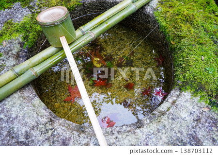 A water basin placed in the garden of a temple in Kyoto in autumn. A water basin placed in the garden of a temple in Kyoto in autumn. 138703112
