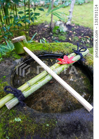 A water basin placed in the garden of a temple in Kyoto in autumn. A water basin placed in the garden of a temple in Kyoto in autumn. 138703114