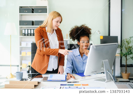 Female discussing new project with male colleague. Young woman talking 138703143