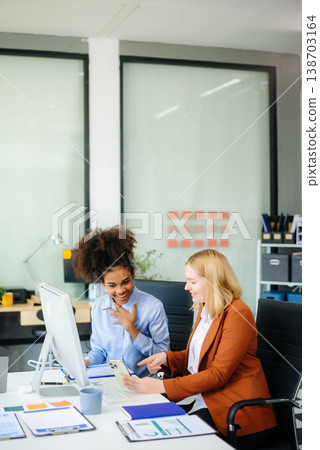 Female discussing new project with male colleague. Young woman talking 138703164