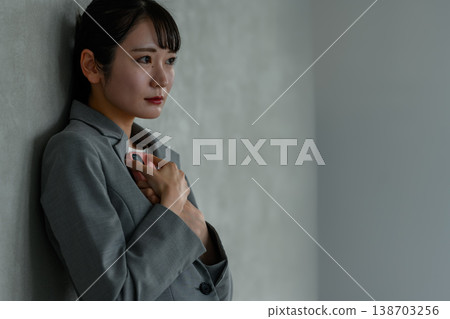 A businesswoman troubled while holding her smartphone 138703256
