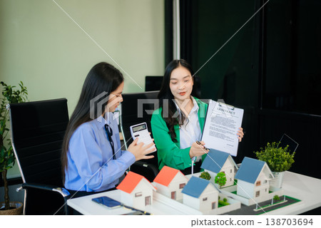 Signing a contract. Client and broker agent, lease agreement, successful deal and Young business sitting Signing a contract. Client and broker agent, lease agreement, successful deal and Young business sitting 138703694