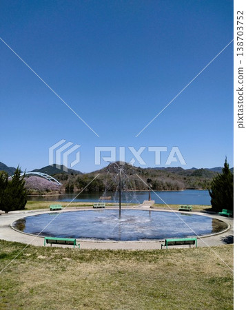 A park with cherry blossoms: Sanda Aono Dam, a water garden with cherry blossoms in full bloom. 138703752