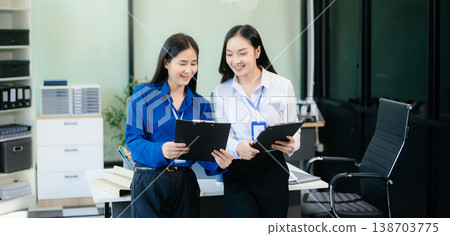 Two Asian businesswoman and man discuss investment project working and planning strategy Two Asian businesswoman and man discuss investment project working and planning strategy 138703775