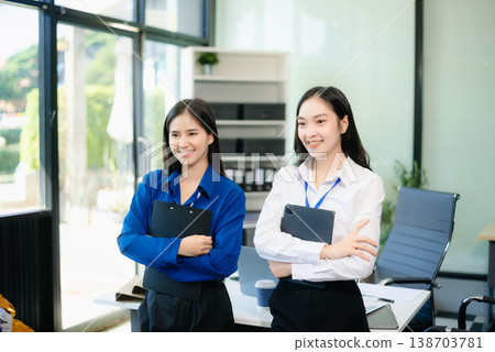Two Asian businesswoman and man discuss investment project working and planning strategy 138703781