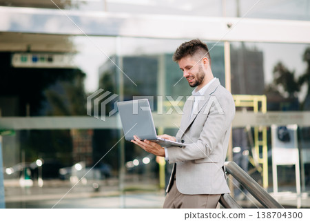 Businessman standing outdoors and using digital tablet. Perfect for corporate, technology, and professional themes Businessman standing outdoors and using digital tablet. Perfect for corporate, technology, and professional themes 138704300