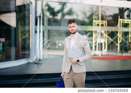 Successful Businessman in suit using tablet outdoors. Perfect for corporate, technology, and professional themes Successful Businessman in suit using tablet outdoors. Perfect for corporate, technology, and professional themes 138704309