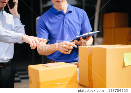 Asian Courier Delivering Package to man Delivery service near van outside the warehouse, delivery home 138704363