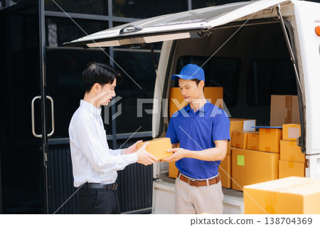 Asian Courier Delivering Package to man Delivery service near van outside the warehouse, delivery home 138704369