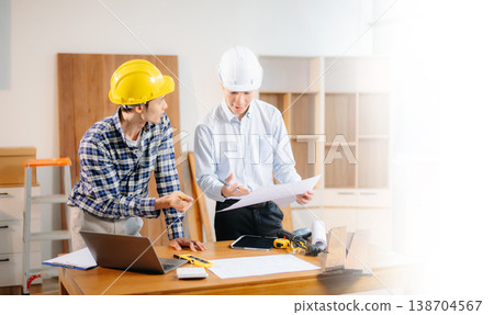 Engineer teams meeting working together wear worker helmets hardhat with on architectural project site and making model house. Engineer teams meeting working together wear worker helmets hardhat with on architectural project site and making model house. 138704567