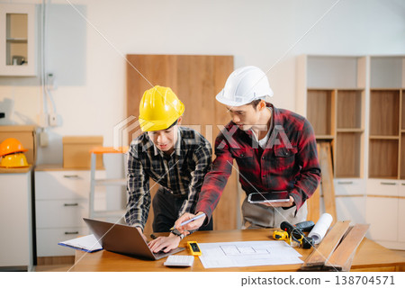 Architects and engineers collaborate on a building model, designing, planning, and measuring with teamwork, precision Architects and engineers collaborate on a building model, designing, planning, and measuring with teamwork, precision 138704571
