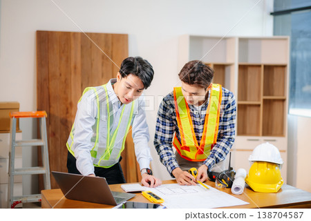Engineer teams meeting working together wear worker helmets hardhat with on architectural project site and making model house. Engineer teams meeting working together wear worker helmets hardhat with on architectural project site and making model house. 138704587