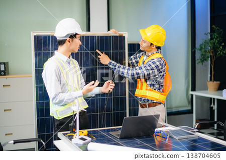 Engineers discuss solar panels and turbines in office, working on clean energy design, sustainable power Engineers discuss solar panels and turbines in office, working on clean energy design, sustainable power 138704605