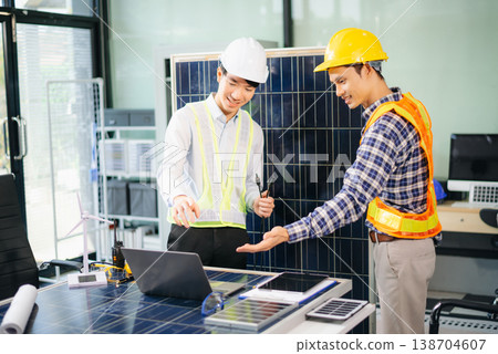 Engineers discuss solar panels and turbines in office, working on clean energy design, sustainable power 138704607