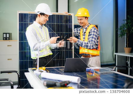 Engineers discuss solar panels and turbines in office, working on clean energy design, sustainable power 138704608