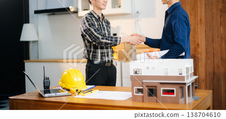 Two colleagues discussing data working and tablet, laptop with architectural project at construction site 138704610